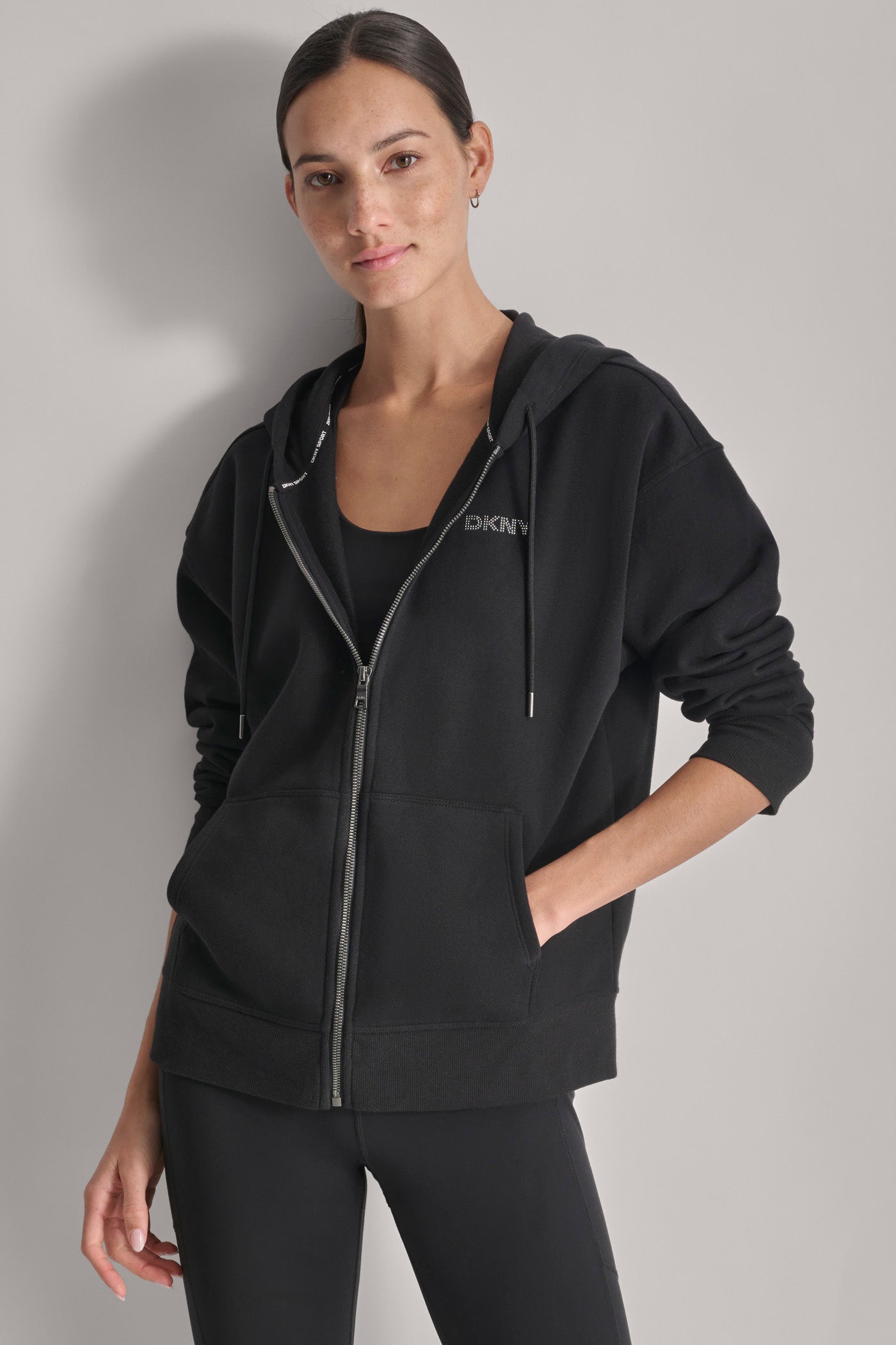 MINI STUD LOGO FULL ZIP HOODIE WITH POCKETS VIEW 1 | DKNY Sport MINI STUD LOGO FULL ZIP HOODIE WITH POCKETS VIEW 1 | DKNY Sport