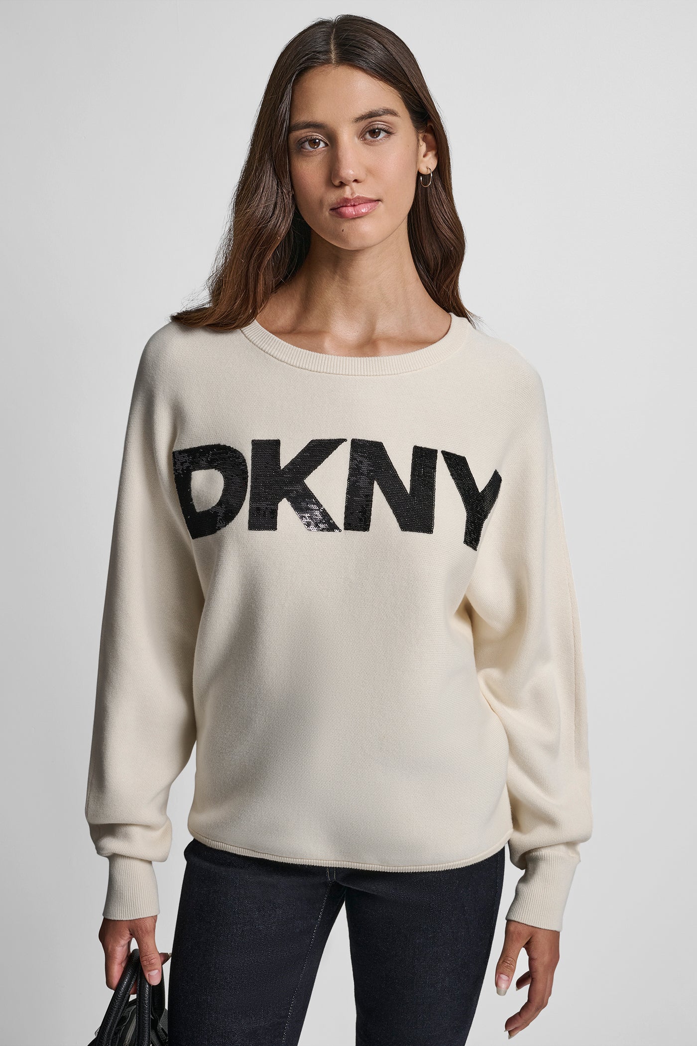 EGGNOG/BLACK DOLMAN SLEEVE SEQUIN LOGO SWEATER, VIEW 1 | DKNY JEANS